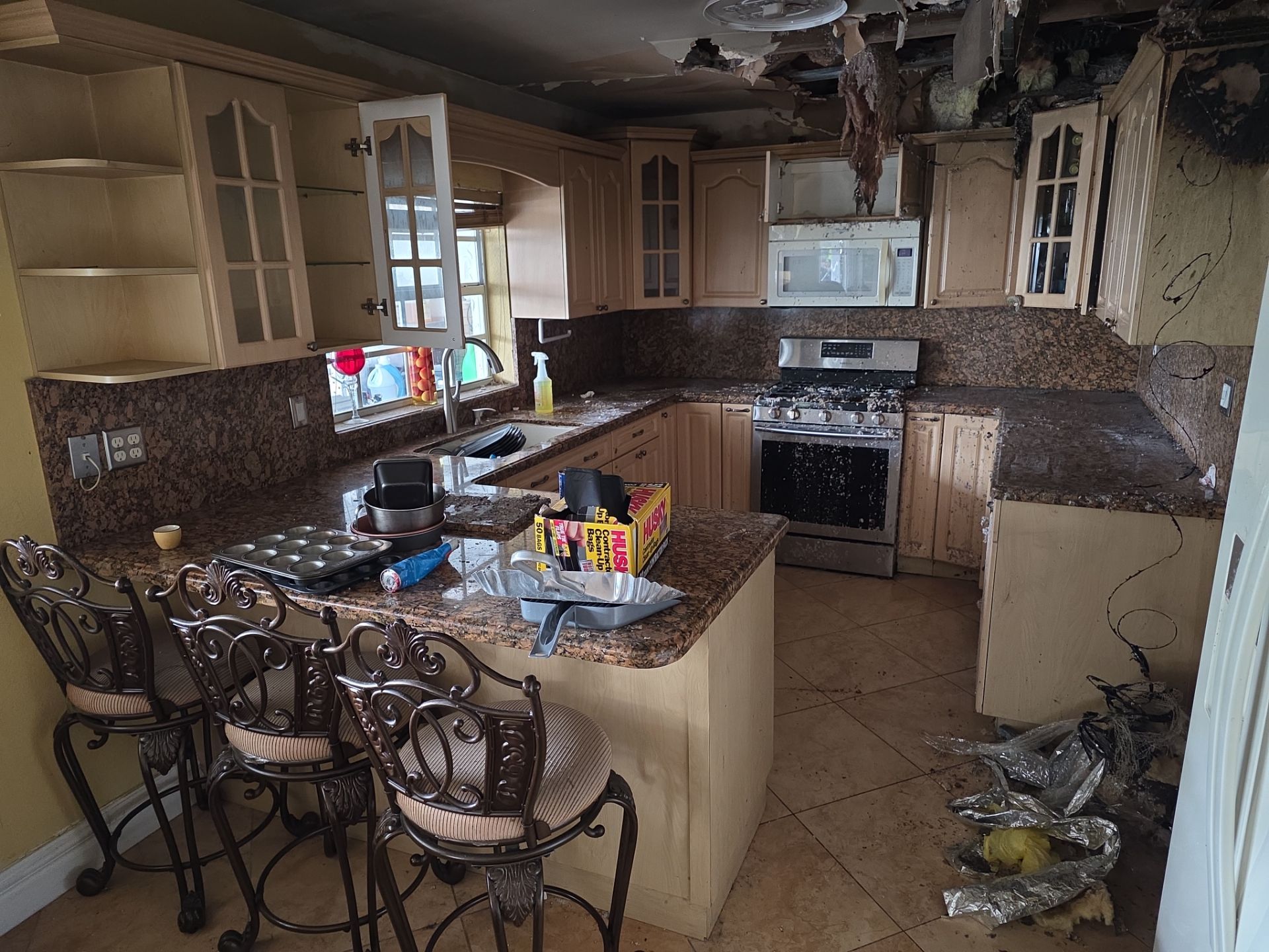 Fire and smoke damage to kitchen ceiling and cabinets